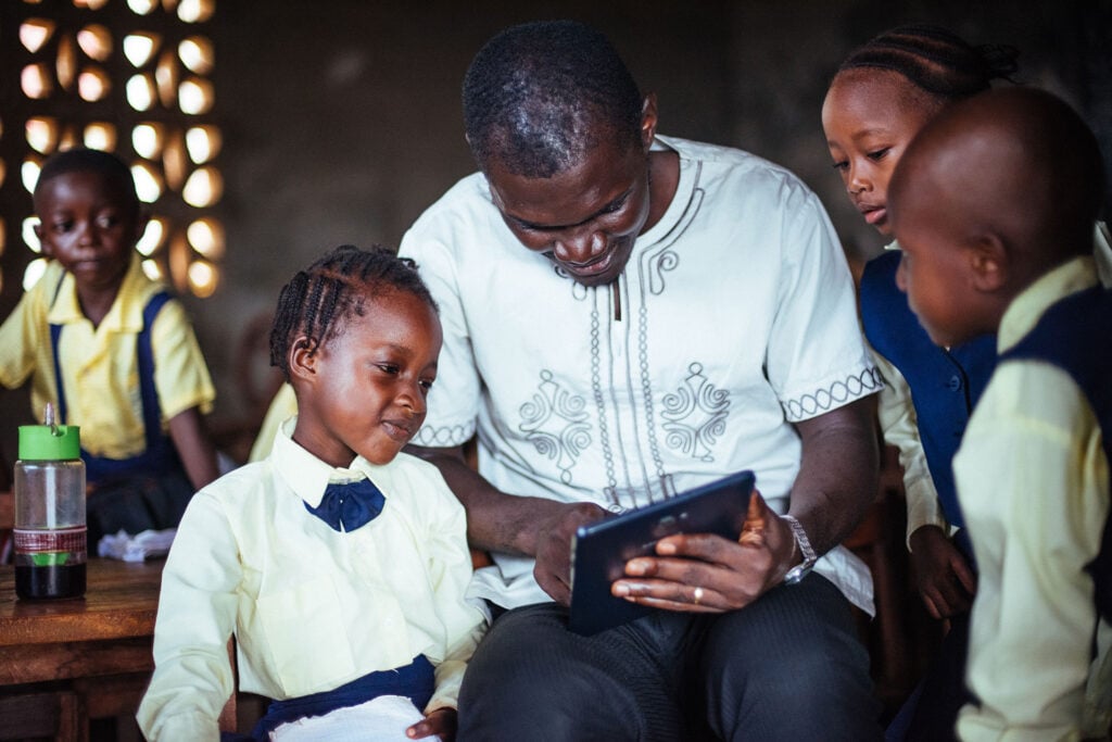 Teacher and student using ed tech in Sierra Leone, Africa