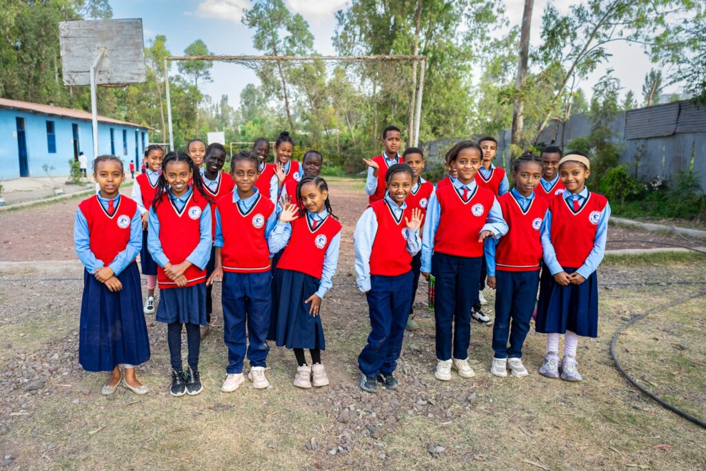 students in Ethiopia at school waving
